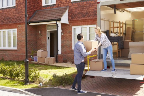 Removal van and boxes outside a typical Enfield home