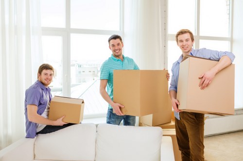 Removal staff unloading items at a property in Enfield
